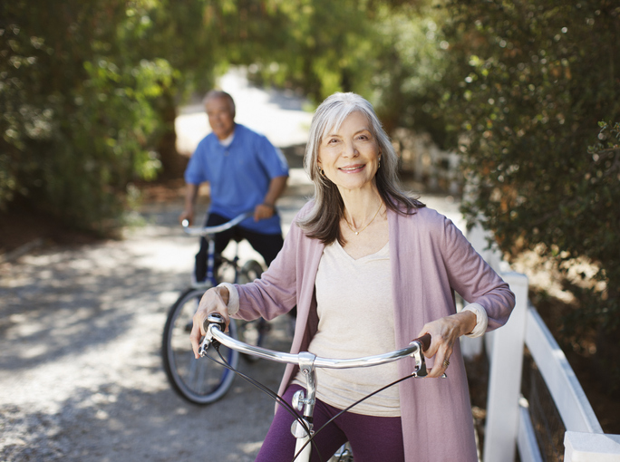 Smiling Older Couple Riding Bicycles